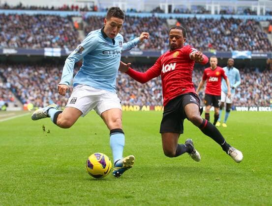 Manchester United s Patrice Evra battles with Manchester City s Samir Nasri - Football - Manchester City v Manchester United - Barclays Premier League - Etihad Stadium Manchester - Season 12 13 - 09 12 12 ..Mandatory Credit: Paul Bradbury Sportimage. EDITORIAL USE ONLY. No use with unauthorised audio, video, data, fixture lists, club league logos or live services. Online in-match use limited to 120 images, no video emulation. No use in betting, games or single club league player publications.