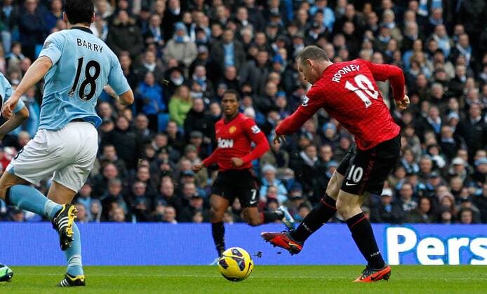 Wayne Rooney (R) of Manchester United scores the opening goal - Barclays Premier League - Manchester City v Manchester United - Etihad Stadium - Manchester - England - 12th December 2012 EDITORIAL USE ONLY. No use with unauthorised audio, video, data, fixture lists, club league logos or live services. Online in-match use limited to 120 images, no video emulation. No use in betting, games or single club league player publications.