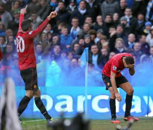 Rio Ferdinand of Manchester Utd is struck by a coin as he celebrates the winning goal - Football - Manchester City v Manchester United - Barclays Premier League - The Hawthorns - Season 12 13 - 09 12 12 - Credit Paul Bradbury Sportimage EDITORIAL USE ONLY. No use with unauthorised audio, video, data, fixture lists, club league logos or live services. Online in-match use limited to 120 images, no video emulation. No use in betting, games or single club league player publications.