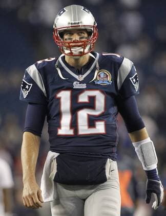 New England Patriots quarterback Tom Brady (12) looks into the stands while warming up before the game against the Houston Texans at Gillette Stadium in Foxborough, Massachusetts on December 10, 2012.  BOS2012121003