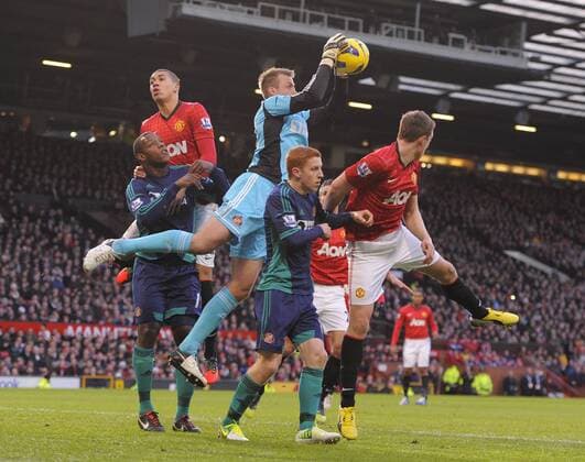 Simon Mignolet of Sunderland collects the ball under pressure. - Barclays Premier League - Manchester United vs AFC Sunderland - Old Trafford Stadium - Manchester - 15 12 12 EDITORIAL USE ONLY. No use with unauthorised audio, video, data, fixture lists, club league logos or live services. Online in-match use limited to 120 images, no video emulation. No use in betting, games or single club league player publications.