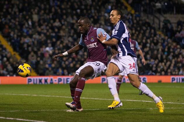Football - 2012 2013 Premier League - West Bromwich Albion vs. West Ham United West Ham s Guy Demel defends against West Brom s Peter Odemwingie at The Hawthorns