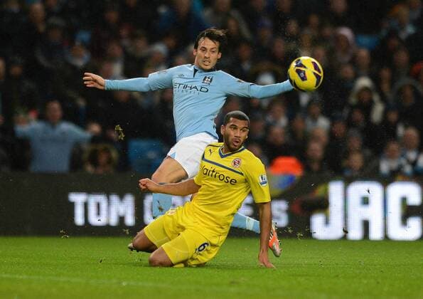 Football - Barclays Premier League - Manchester City vs. Reading FC Manchester City s David Silva and Adrian Mariappa of Reading FC in action at the Etihad Stadium, Manchester 
