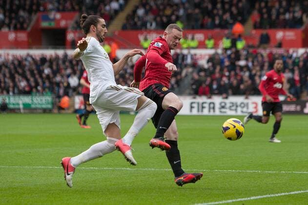 Football - 2012 2013 Premier League - Swansea vs. Manchester United Swansea s Chico Flores and Wayne Rooney of Manchester United at the Liberty Stadium 