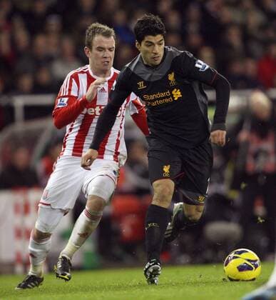 Luis Suarez holds off Glen Whelan of Stoke- Barclays Premier League - Stoke City vs Liverpool - Britannia Stadium - Stoke on Trent - 26th December 2012 - Credit Paul Bradbury Sportimage EDITORIAL USE ONLY. No use with unauthorised audio, video, data, fixture lists, club league logos or live services. Online in-match use limited to 120 images, no video emulation. No use in betting, games or single club league player publications.