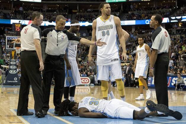 A flagrant foul by Los Angeles Lakers center Dwight Howard left Denver Nuggets forward Kenneth Faried flat on the floor during the third quarter at the Pepsi Center on December 26, 2012 in Denver. Howard was ejected from the game for the foul. The Nuggets stopped the Lakers winning streak with a 126-114 victory.  DEN2012122627