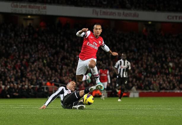 Arsenal s Theo Walcott goes past Newcastle s James Perch..- Arsenal v Newcastle United - Barclays Premier League - the Emirates Stadium, London- 29 12 12 - Picture David Klein Sportimage EDITORIAL USE ONLY. No use with unauthorised audio, video, data, fixture lists, club league logos or live services. Online in-match use limited to 120 images, no video emulation. No use in betting, games or single club league player publications.