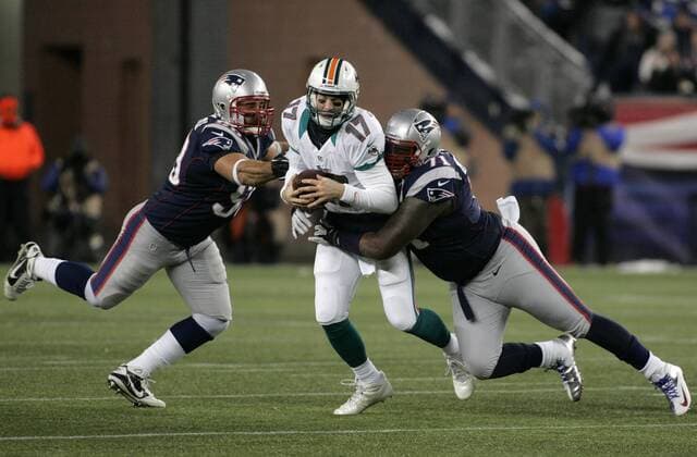 Miami Dolphins quarterback Ryan Tannehill (17) is sacked by New England Patriots defensive linemen Brandon Deaderick (71) and Rob Ninkovich (50) quarter at Gillette Stadium in Foxborough, Massachusetts on December 30, 2012. The Patriots defeated the Dolphins 28-0.  BOS2012123013