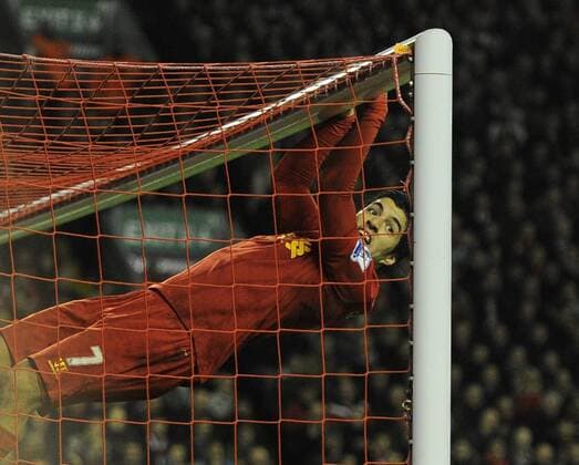 Luis Suarez of Liverpool swings on the crossbar after missing a chance to score a hat trick - Barclays Premier League - Liverpool vs Sunderland - Anfield Stadium - Liverpool - 02 01 13 - Picture Simon Bellis Sportimage EDITORIAL USE ONLY. No use with unauthorised audio, video, data, fixture lists, club league logos or live services. Online in-match use limited to 120 images, no video emulation. No use in betting, games or single club league player publications.