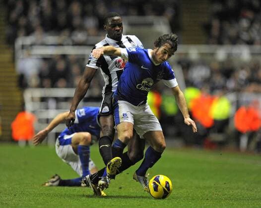 Newcastle United s Shola Ameobi tackles Leighton Baines of Everton (R) - Barclays Premier League - Newcastle United vs Everton - St. James Park - Newcastle - 02 01 13 - Picture Richard Lee Sportimage EDITORIAL USE ONLY. No use with unauthorised audio, video, data, fixture lists, club league logos or live services. Online in-match use limited to 120 images, no video emulation. No use in betting, games or single club league player publications.