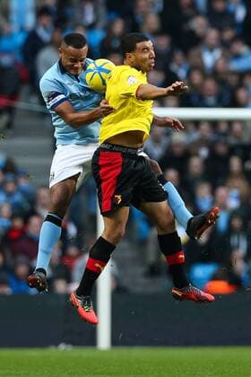 Football - 2012 2013 FA Cup - Third Round: Manchester City vs. Watford FC Watford s Troy Deeney and Manchester City s Vincent Kompany at Etihad Stadium, Manchester 