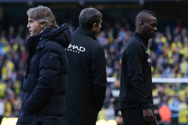 Football - 2012 2013 FA Cup - Third Round: Manchester City vs. Watford FC Manchester City s Mario Balotelli (right) walks past Manchester City Manager, Roberto Mancini (left) without saying a word to him at Etihad Stadium, Manchester 