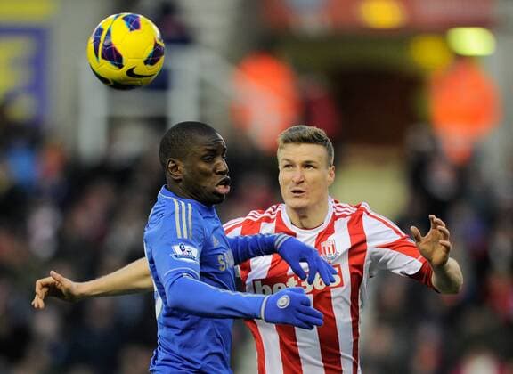 Demba Ba of Chelsea FC London flicks the ball past Robert Huth of Stoke City - Barclays Premier League - Stoke City vs Chelsea - Britannia Stadium - Stoke on Trent - 12 01 13 - Picture Simon Bellis Sportimage EDITORIAL USE ONLY. No use with unauthorised audio, video, data, fixture lists, club league logos or live services. Online in-match use limited to 120 images, no video emulation. No use in betting, games or single club league player publications.