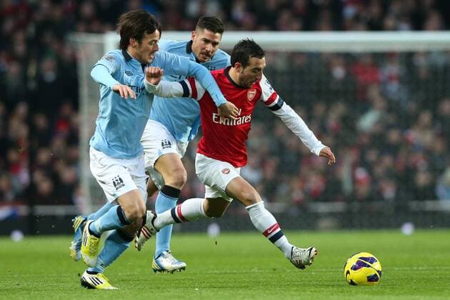 Football - 2012 2013 Premier League - FC Arsenal London vs. Manchester City Arsenal s Santi Cazorla takes the ball around Manchester City s David Silva at the Emirates Stadium, London 