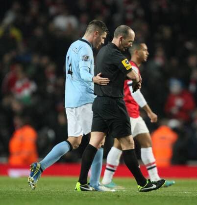 FC Arsenal London vs. Manchester City . . 13.01.13 Javi Garcia (MC) puts his arm around referee Mike Dean as they walk off at half time. 