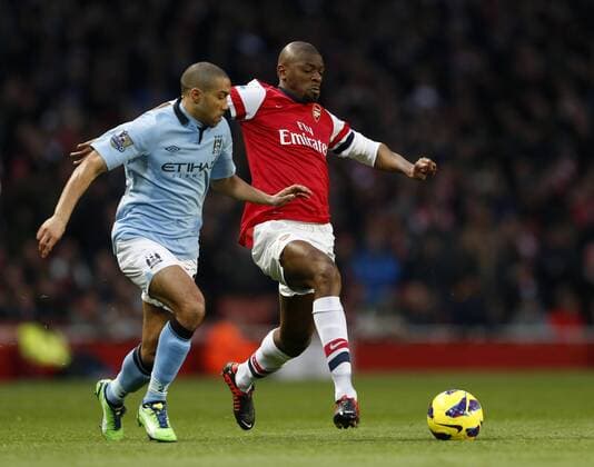 Arsenal s Abou Diaby tussles with Manchester City s Gael Clichy.. FC Arsenal London vs. Manchester City - Barclays Premier League - Emirates Stadium, London- 13 01 13 EDITORIAL USE ONLY. No use with unauthorised audio, video, data, fixture lists, club league logos or live services. Online in-match use limited to 120 images, no video emulation. No use in betting, games or single club league player publications.