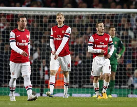 Arsenal s Jack Wilshere looks on dejected after going 2-0 down. On the left Per Mertesacker. FC Arsenal London vs. Manchester City - Barclays Premier League - Emirates Stadium, London- 13 01 13 EDITORIAL USE ONLY. No use with unauthorised audio, video, data, fixture lists, club league logos or live services. Online in-match use limited to 120 images, no video emulation. No use in betting, games or single club league player publications.