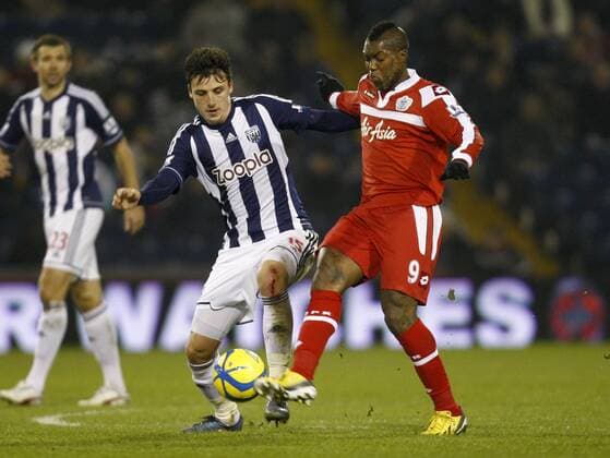 Football- 2012 13 FA Cup-3rd Round Replay-West Bromwich Albion vs. Queens Park Ranges - West Brom s George Thorne and Queens Park Rangers (QPR) Djibril Cisse battle for the ball at the Hawthorns 