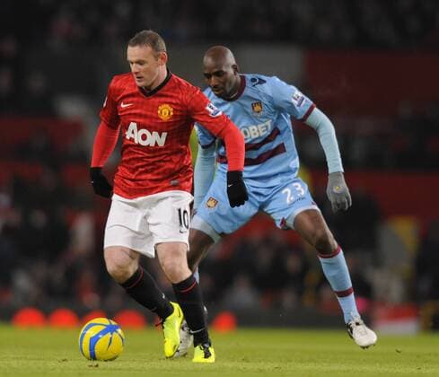 Wayne Rooney of Manchester United with Alou Diarra of West Ham United - FA Cup 3rd Round replay - Manchester United ManU vs West Ham United - Old Trafford Stadium - Manchester - 16 01 13 - EDITORIAL USE ONLY. No use with unauthorised audio, video, data, fixture lists, club league logos or live services. Online in-match use limited to 120 images, no video emulation. No use in betting, games or single club league player publications.