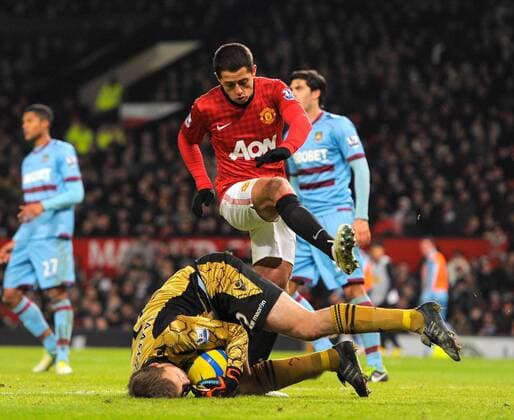 Javier Hernandez of Manchester United leaps over Jussi Jaaskelainen of West Ham United - FA Cup 3rd Round replay - Manchester Utd vs West Ham Utd - Old Trafford Stadium - Manchester - 16 01 13 - Picture Simon Bellis Sportimage EDITORIAL USE ONLY. No use with unauthorised audio, video, data, fixture lists, club league logos or live services. Online in-match use limited to 120 images, no video emulation. No use in betting, games or single club league player publications.