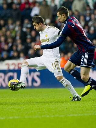 Football - 2012 2013 Premier League - Swansea City vs. Stoke City pablo Hernandez takes on geoff cameron 