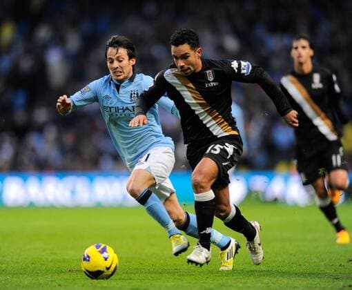 David Silva of Manchester City chases after Kieran Richardson of Fulham FC - Barclays Premier League - Manchester City vs FC Fulham - Etihad Stadium - Manchester - 13 01 13 - Picture Simon Bellis Sportimage EDITORIAL USE ONLY. No use with unauthorised audio, video, data, fixture lists, club league logos or live services. Online in-match use limited to 120 images, no video emulation. No use in betting, games or single club league player publications.