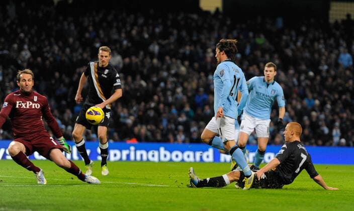 David Silva of Manchester City chips the ball past Mark Schwarzer of Fulham FC for the second goal - Barclays Premier League - Manchester City vs FC Fulham - Etihad Stadium - Manchester - 13 01 13 - Picture Simon Bellis Sportimage EDITORIAL USE ONLY. No use with unauthorised audio, video, data, fixture lists, club league logos or live services. Online in-match use limited to 120 images, no video emulation. No use in betting, games or single club league player publications.