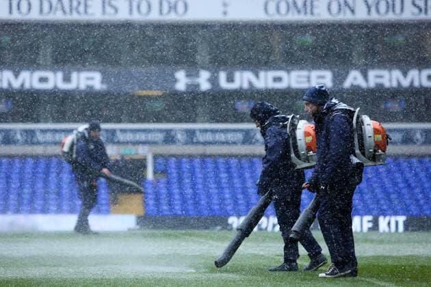 Football - 2012 2013 Premier League - Tottenham Hotspur vs. Manchester United ManU Groundsmen clear snow with leaf blowers at White Hart Lane, London 