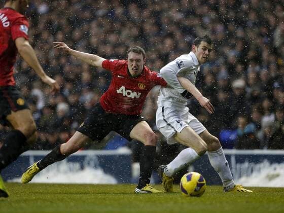 Tottenham s Gareth Bale tussles with Manchester United ManU s Phil Jones - Tottenham Hotspur vs Manchester United ManU - Barclays Premier League - White Hart Lane, London- 20 01 13 - Picture David Klein Sportimage EDITORIAL USE ONLY. No use with unauthorised audio, video, data, fixture lists, club league logos or live services. Online in-match use limited to 120 images, no video emulation. No use in betting, games or single club league player publications.