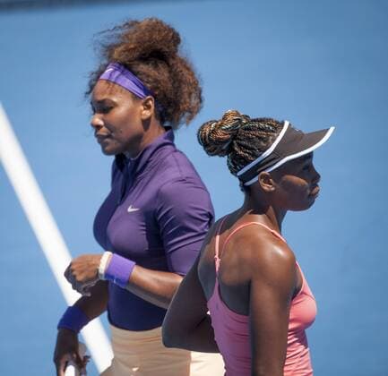 Jan. 22, 2013 - Venus Williams (USA) (pink shirt) and sister Serena Williams (USA) (purple shirt) have been upset in 2013 Womens Doubles play at Margaret Court Arena in Melbourne. Williams Sisters Upset in Australian Open - ZUMAkh1