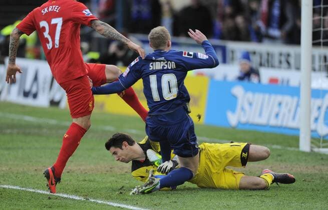 Robbie Simpson of Oldham Athletic leaves his foot in a tackle as Brad Jones of Liverpool collects the ball - FA Cup 4th Round - Oldham Athletic vs Liverpool - Boundary Park Stadium - Oldham - 27 01 13 - Picture Simon Bellis Sportimage EDITORIAL USE ONLY. No use with unauthorised audio, video, data, fixture lists, club league logos or live services. Online in-match use limited to 120 images, no video emulation. No use in betting, games or single club league player publications.