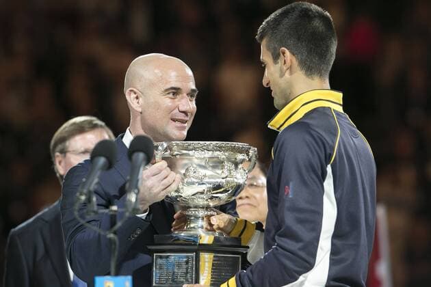 27 January 2013 : Andre Agassi hands the winners trophy to Novak Djokovic during Day 14 of the Mens final at Rod Laver Arena at the Australian Tennis open Grand Slam event at Melbourne Park, Melbourne Australia. TENNIS: JAN 27 Australian Open Icon1301270155 EDITORIAL USE ONLY