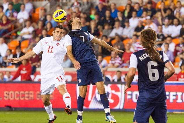 29 JANUARY, 2013: Canadian National Soccer M Russell Teibert (11) and U.S. National Soccer M Graham Zusi (7) jump in the air to retrieve the ball during a friendly match at BBVA Compass Stadium in Houston, TX. SOCCER: JAN 29 International Friendly - Canada at USA Icon20130129004 EDITORIAL USE ONLY