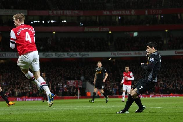 Football - 2012 2013 Premier League - Arsenal FC vs Liverpool FC Liverpool s Luis Suarez scoring at the Emirates Stadium, London, Per Mertesacker (L) 