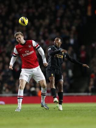Arsenal s Per Mertesacker tussles with Liverpool s Daniel Sturridge.. - FC Arsenal vs FC Liverpool - Barclays Premier League - Emirates Stadium, London- 30 01 13 - EDITORIAL USE ONLY. No use with unauthorised audio, video, data, fixture lists, club league logos or live services. Online in-match use limited to 120 images, no video emulation. No use in betting, games or single club league player publications.
