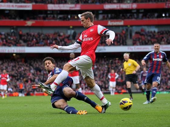 Arsenal s Nacho Monreal tussles with Stoke s Ryan Shotton..Arsenal v Stoke - Barclays Premier League - Emirates Stadium, London- 02 02 13 - Picture David Klein Sportimage EDITORIAL USE ONLY. No use with unauthorised audio, video, data, fixture lists, club league logos or live services. Online in-match use limited to 120 images, no video emulation. No use in betting, games or single club league player publications.
