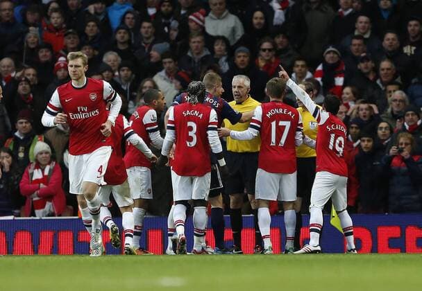 Arsenal s players argue with referee Chris Foy and linesman David Bryan after initially their opening goal was disallowed...Arsenal v Stoke - Barclays Premier League - Emirates Stadium, London- 02 02 13 - Picture David Klein Sportimage EDITORIAL USE ONLY. No use with unauthorised audio, video, data, fixture lists, club league logos or live services. Online in-match use limited to 120 images, no video emulation. No use in betting, games or single club league player publications.