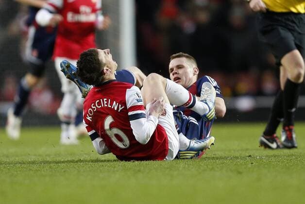 Stoke s Ryan Shawcross gets booked for this tackle on Arsenal s Laurent Koscielny..Arsenal v Stoke - Barclays Premier League - Emirates Stadium, London- 02 02 13 - Picture David Klein Sportimage EDITORIAL USE ONLY. No use with unauthorised audio, video, data, fixture lists, club league logos or live services. Online in-match use limited to 120 images, no video emulation. No use in betting, games or single club league player publications.