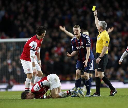 Stoke s Ryan Shawcross gets booked for this tackle on Arsenal s Laurent Koscielny..Arsenal v Stoke - Barclays Premier League - Emirates Stadium, London- 02 02 13 - Picture David Klein Sportimage EDITORIAL USE ONLY. No use with unauthorised audio, video, data, fixture lists, club league logos or live services. Online in-match use limited to 120 images, no video emulation. No use in betting, games or single club league player publications.