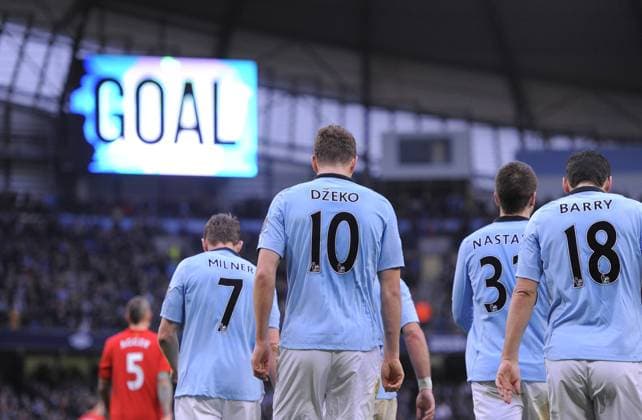 Edin Dzeko of Manchester City walks back after scoring the first goal - Barclays Premier League - Manchester City vs Liverpool - Etihad Stadium - Manchester - 03 02 13 - Picture Simon Bellis Sportimage EDITORIAL USE ONLY. No use with unauthorised audio, video, data, fixture lists, club league logos or live services. Online in-match use limited to 120 images, no video emulation. No use in betting, games or single club league player publications.