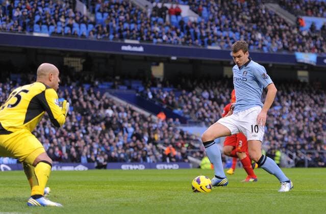 Edin Dzeko of Manchester City scores the first goal past Jose Manuel Reina of Liverpool - Barclays Premier League - Manchester City vs Liverpool - Etihad Stadium - Manchester - 03 02 13 - Picture Simon Bellis Sportimage EDITORIAL USE ONLY. No use with unauthorised audio, video, data, fixture lists, club league logos or live services. Online in-match use limited to 120 images, no video emulation. No use in betting, games or single club league player publications.
