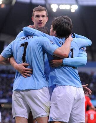 Edin Dzeko of Manchester City celebrates scoring the first goal - Barclays Premier League - Manchester City vs Liverpool - Etihad Stadium - Manchester - 03 02 13 - Picture Simon Bellis Sportimage EDITORIAL USE ONLY. No use with unauthorised audio, video, data, fixture lists, club league logos or live services. Online in-match use limited to 120 images, no video emulation. No use in betting, games or single club league player publications.