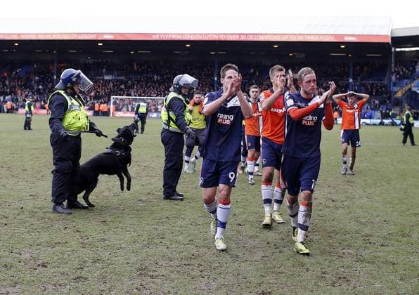 Luton s players trudge off at the final whistle as Police and their dogs look on..Luton Town FC vs. Millwall FC - FA Cup 5th Round - Kenilworth Road, Luton- 16 02 13 - EDITORIAL USE ONLY. No use with unauthorised audio, video, data, fixture lists, club league logos or live services. Online in-match use limited to 120 images, no video emulation. No use in betting, games or single club league player publications.
