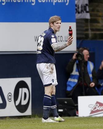 Millwall s Andy Keogh shows off the bottle thrown from the crowd..FC Luton Town v FC Millwall - FA Cup 5th Round - Kenilworth Road, Luton- 16 02 13 - EDITORIAL USE ONLY. No use with unauthorised audio, video, data, fixture lists, club league logos or live services. Online in-match use limited to 120 images, no video emulation. No use in betting, games or single club league player publications.
