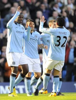 Yaya Toure of Manchester City (L) is congratulated by his team mates after opening the scoring - FA Cup 5th Round - Manchester City vs Leeds Utd - Etihad Stadium - Manchester - 17 02 13 - EDITORIAL USE ONLY. No use with unauthorised audio, video, data, fixture lists, club league logos or live services. Online in-match use limited to 120 images, no video emulation. No use in betting, games or single club league player publications.