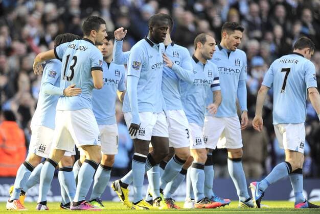 Yaya Toure of Manchester City is congratulated by his team mates after opening the scoring - FA Cup 5th Round - Manchester City vs Leeds Utd - Etihad Stadium - Manchester - 17 02 13 - EDITORIAL USE ONLY. No use with unauthorised audio, video, data, fixture lists, club league logos or live services. Online in-match use limited to 120 images, no video emulation. No use in betting, games or single club league player publications.