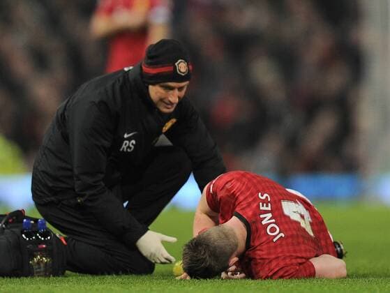 Phil Jones of Manchester United lies injured he was substituted - FA Cup 5th Round - Manchester Utd vs Reading - Old Trafford Stadium - Manchester - 18 02 13 - Picture Simon Bellis Sportimage EDITORIAL USE ONLY. No use with unauthorised audio, video, data, fixture lists, club league logos or live services. Online in-match use limited to 120 images, no video emulation. No use in betting, games or single club league player publications.