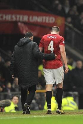 Phil Jones of Manchester United lies injured he was substituted - FA Cup 5th Round - Manchester Utd vs Reading - Old Trafford Stadium - Manchester - 18 02 13 - Picture Simon Bellis Sportimage EDITORIAL USE ONLY. No use with unauthorised audio, video, data, fixture lists, club league logos or live services. Online in-match use limited to 120 images, no video emulation. No use in betting, games or single club league player publications.