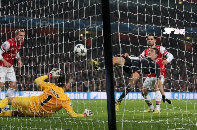 Munich s Thomas Muller scoring his sides second goal..Arsenal v Bayern Munich - Champions League Second Round, First Leg- Emirates Stadium, London- 19 02 13 - Picture David Klein Sportimage EDITORIAL USE ONLY. No use with unauthorised audio, video, data, fixture lists, club league logos or live services. Online in-match use limited to 120 images, no video emulation. No use in betting, games or single club league player publications.