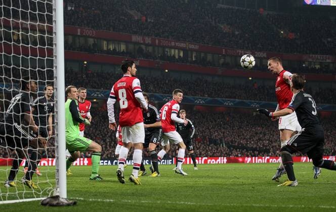 Arsenal s Lukas Podolski scoring his sides opening goal..Arsenal v Bayern Munich - Champions League Second Round, First Leg- Emirates Stadium, London- 19 02 13 - Picture David Klein Sportimage EDITORIAL USE ONLY. No use with unauthorised audio, video, data, fixture lists, club league logos or live services. Online in-match use limited to 120 images, no video emulation. No use in betting, games or single club league player publications.